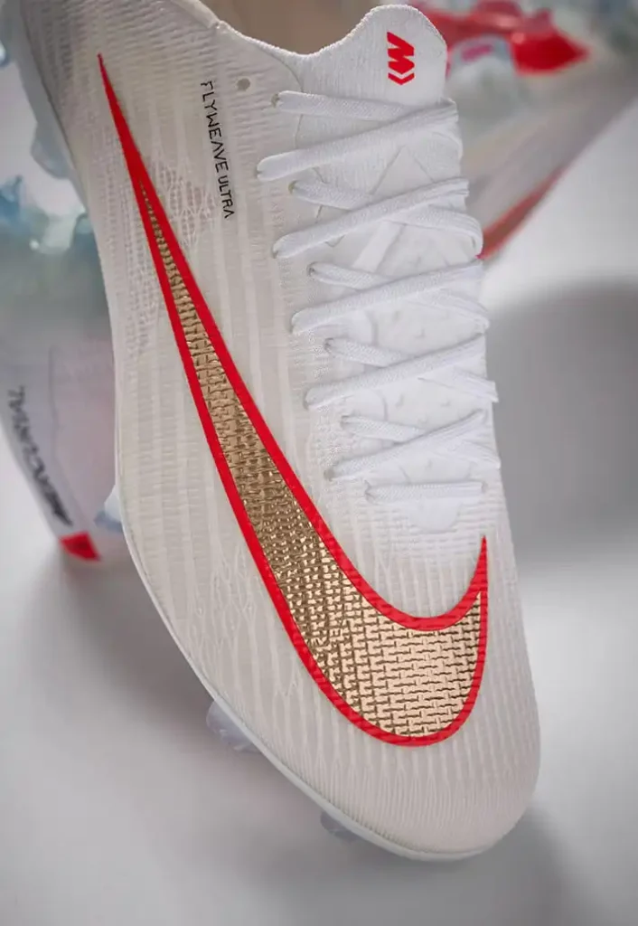 White Nike Mercurial Superfly 11 Elite with crimson and gold detailing.
