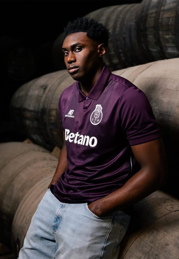 Close-up of the monochromatic white club crest and New Balance logo on the FC Porto 2026/27 away kit.