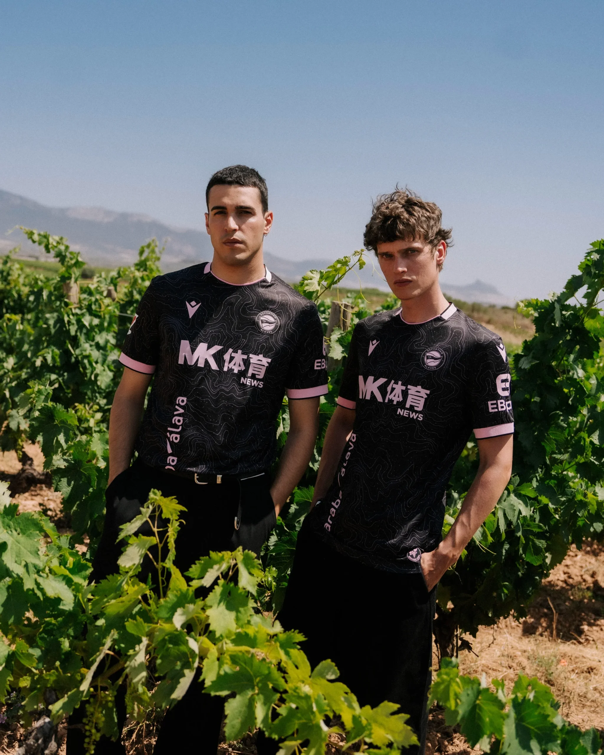 The monochromatic pastel pink 3D silicone Deportivo Alavés club crest and Macron Hero logo on the new away jersey